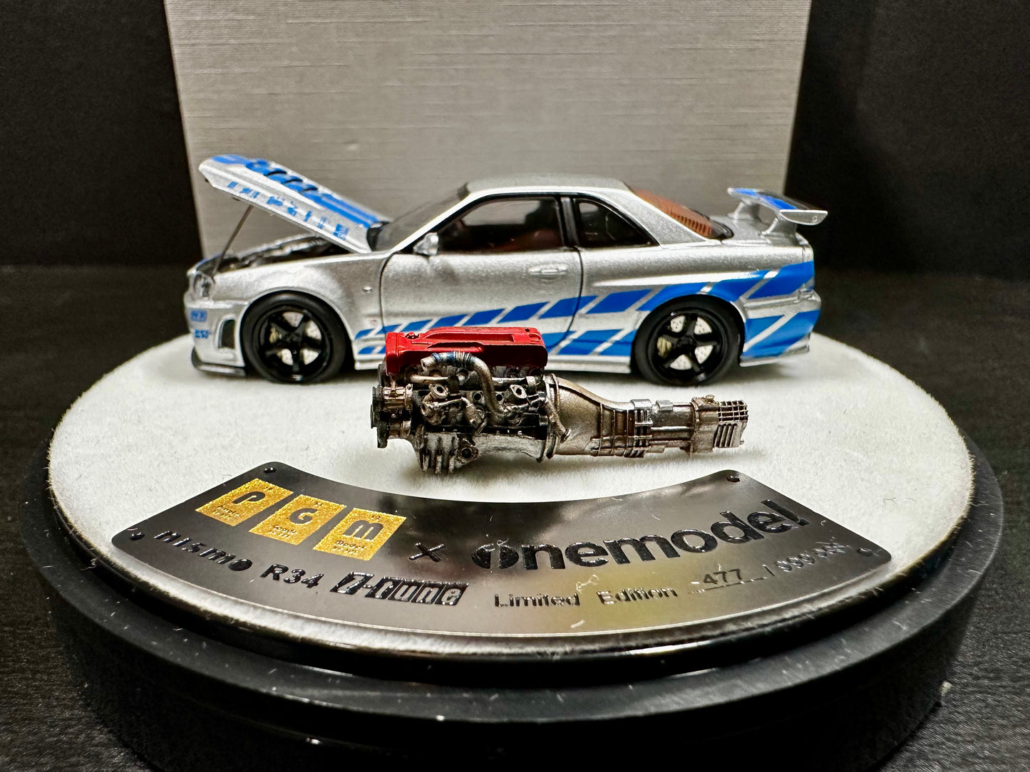 x One Model 1/64 Nissan Skyline GT-R R34 Z-Tune Silver w/ Blue Strip Luxury Round Stand Ver(1 pc)