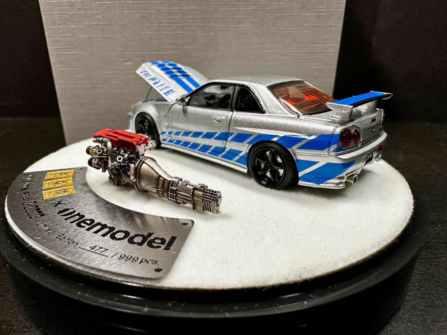 x One Model 1/64 Nissan Skyline GT-R R34 Z-Tune Silver w/ Blue Strip Luxury Round Stand Ver(1 pc)